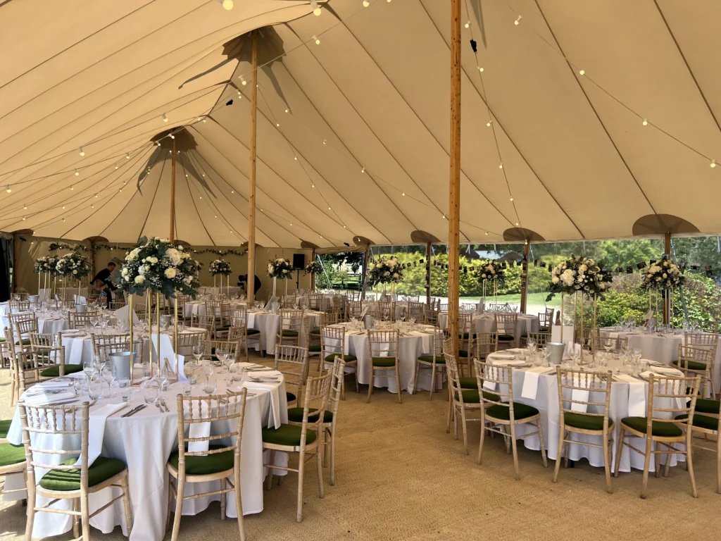 Classic white floral pedestal arrangements on gold stands at The Lakes by Yoo marquee wedding