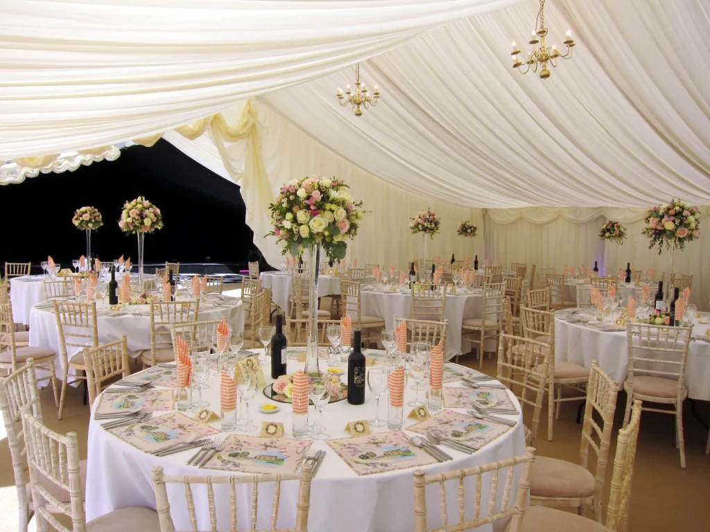 Lily vase wedding centrepieces with roses at the base, inspired by an English country garden wedding theme